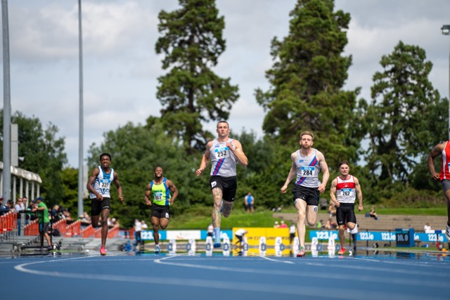 Relay team exchanging baton